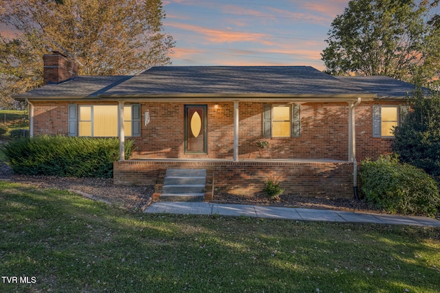 single story home featuring a lawn