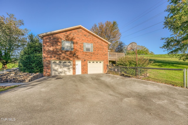 view of side of property with a garage and a yard