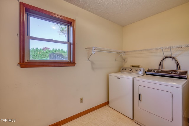 laundry room featuring independent washer and dryer and a textured ceiling