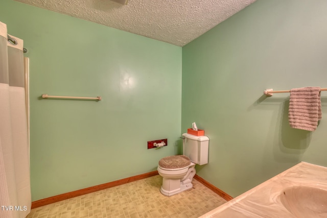 bathroom featuring a textured ceiling and toilet