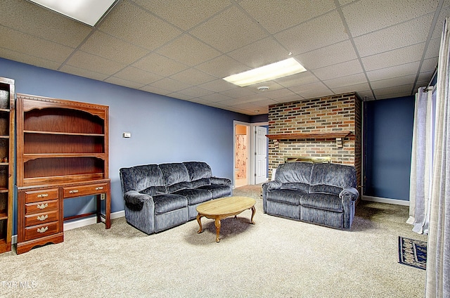 carpeted living room with a paneled ceiling and a fireplace