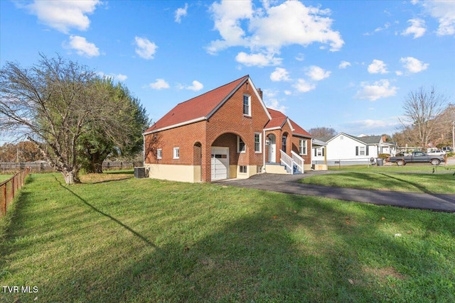 view of front of home with central AC unit and a front yard