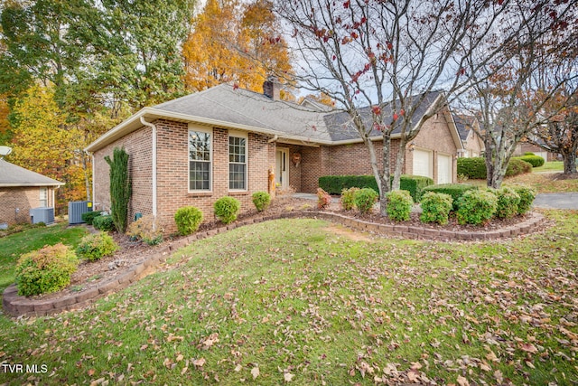 view of front of property featuring central air condition unit, a garage, and a front lawn