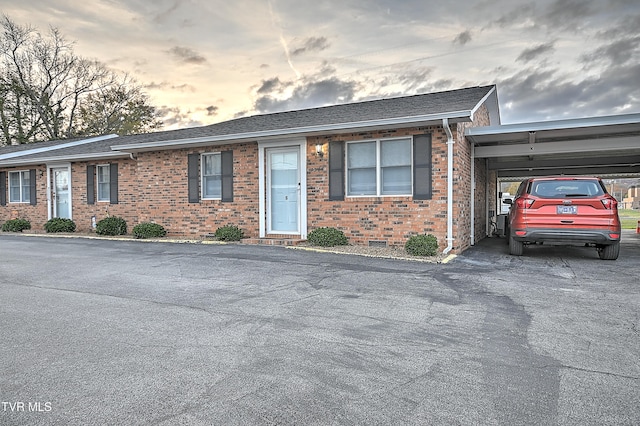 ranch-style home featuring a carport