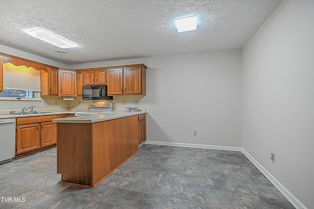 kitchen featuring a textured ceiling, kitchen peninsula, range, and dishwasher