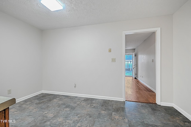 spare room with a textured ceiling