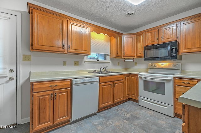 kitchen with white appliances, a textured ceiling, and sink