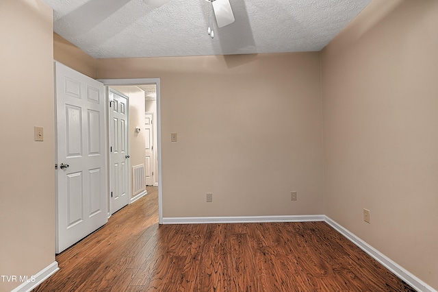 empty room featuring hardwood / wood-style flooring and a textured ceiling