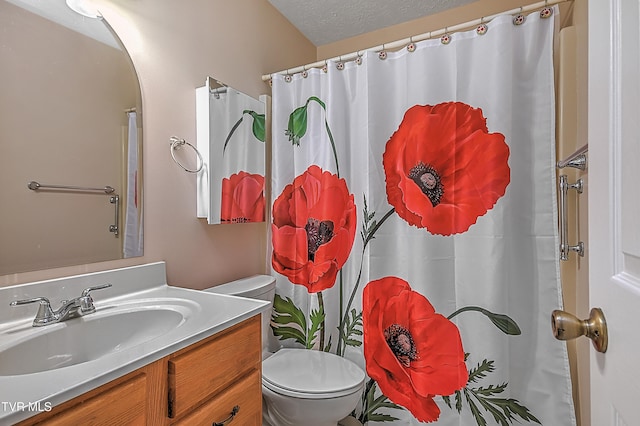 bathroom with toilet, vanity, a textured ceiling, and a shower with shower curtain