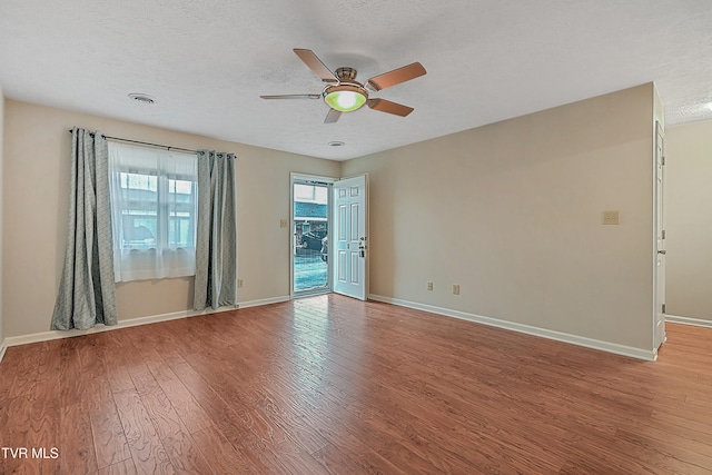 unfurnished room with ceiling fan, a textured ceiling, and light hardwood / wood-style floors