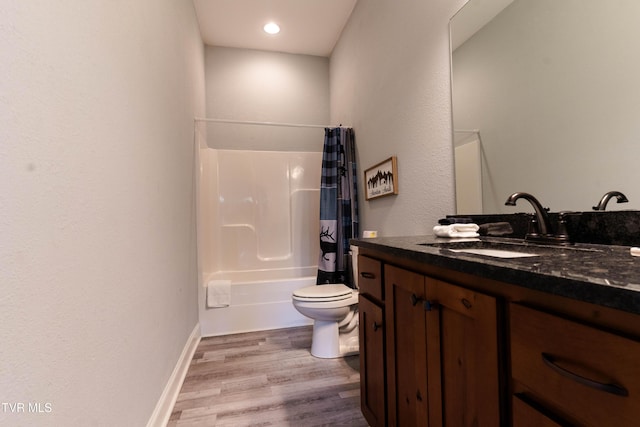 full bathroom with hardwood / wood-style floors, shower / bath combination with curtain, toilet, and vanity