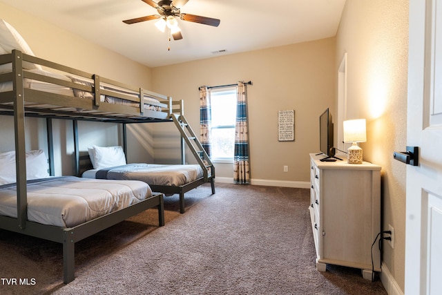 bedroom featuring ceiling fan and dark colored carpet