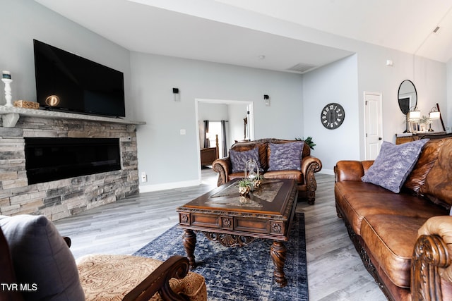 living room with a fireplace and wood-type flooring