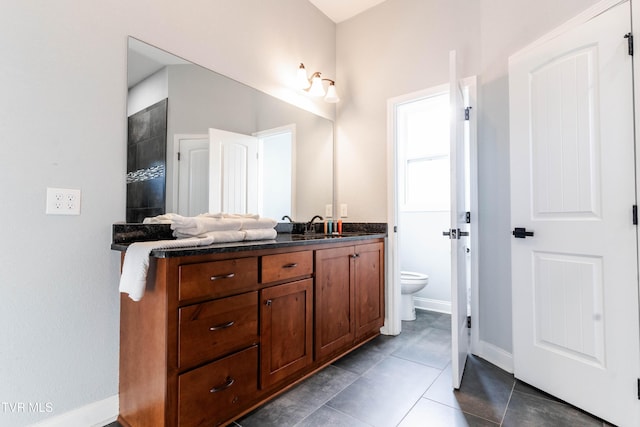 bathroom with tile patterned flooring, a shower, vanity, and toilet