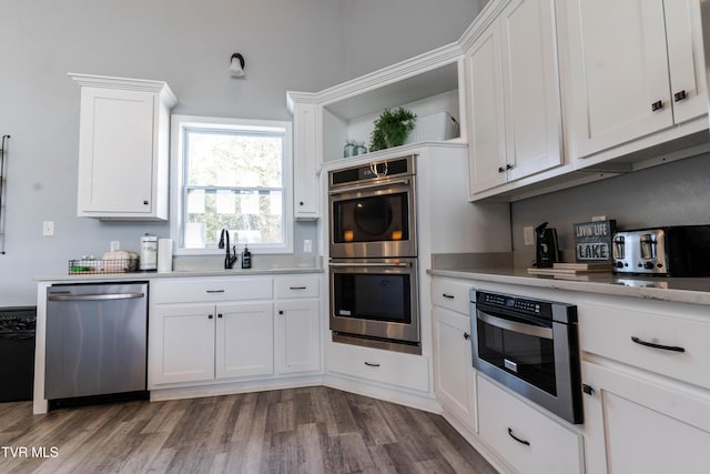 kitchen featuring white cabinetry, dark wood-type flooring, and appliances with stainless steel finishes