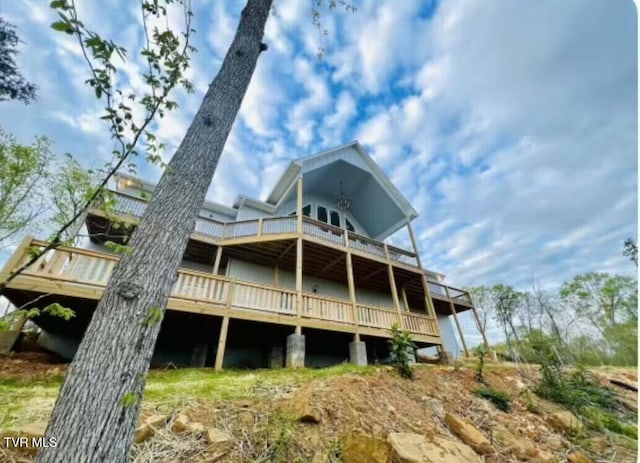 back of house featuring a balcony