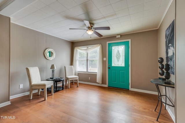 sitting room with ornamental molding, ceiling fan, and light hardwood / wood-style flooring