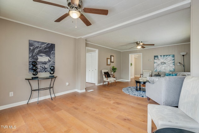 living room featuring ornamental molding, hardwood / wood-style floors, and ceiling fan