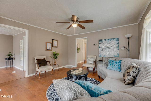 living room featuring ornamental molding, hardwood / wood-style floors, and ceiling fan