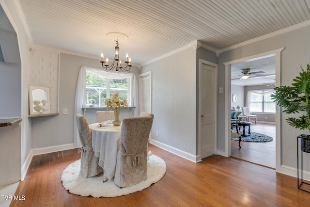 dining room featuring hardwood / wood-style floors, ceiling fan with notable chandelier, and ornamental molding