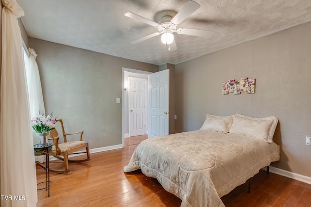 bedroom featuring hardwood / wood-style floors and ceiling fan