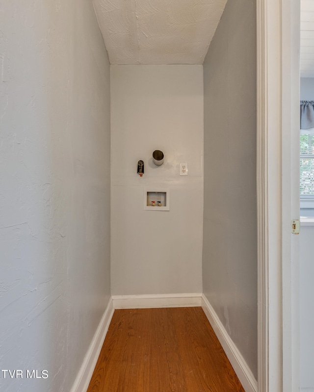 laundry room featuring washer hookup and wood-type flooring