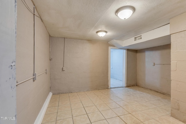 basement featuring a textured ceiling