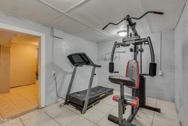 workout area featuring tile patterned flooring