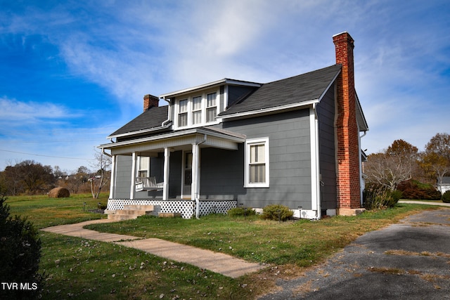 view of front of home featuring a front yard and a porch