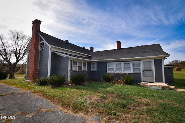 rear view of house with a lawn