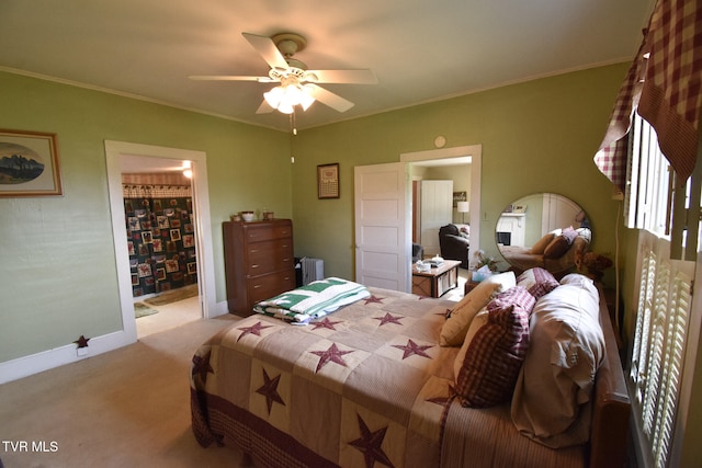 bedroom with light colored carpet, radiator, ceiling fan, a closet, and a spacious closet