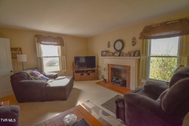 living room with a brick fireplace and carpet