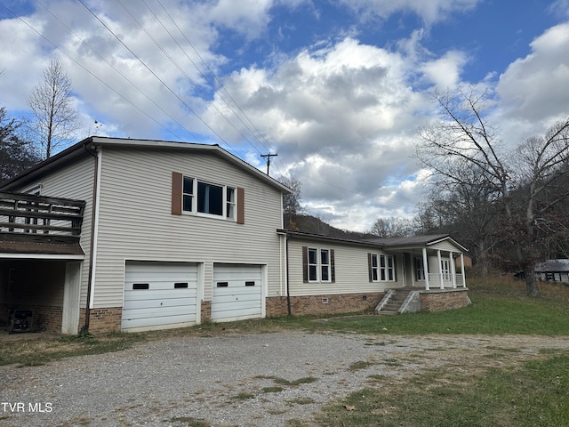 11511 Meade Fork Rd, Pound, VA 24279 - view of side of property with gravel driveway, a garage, and a porch