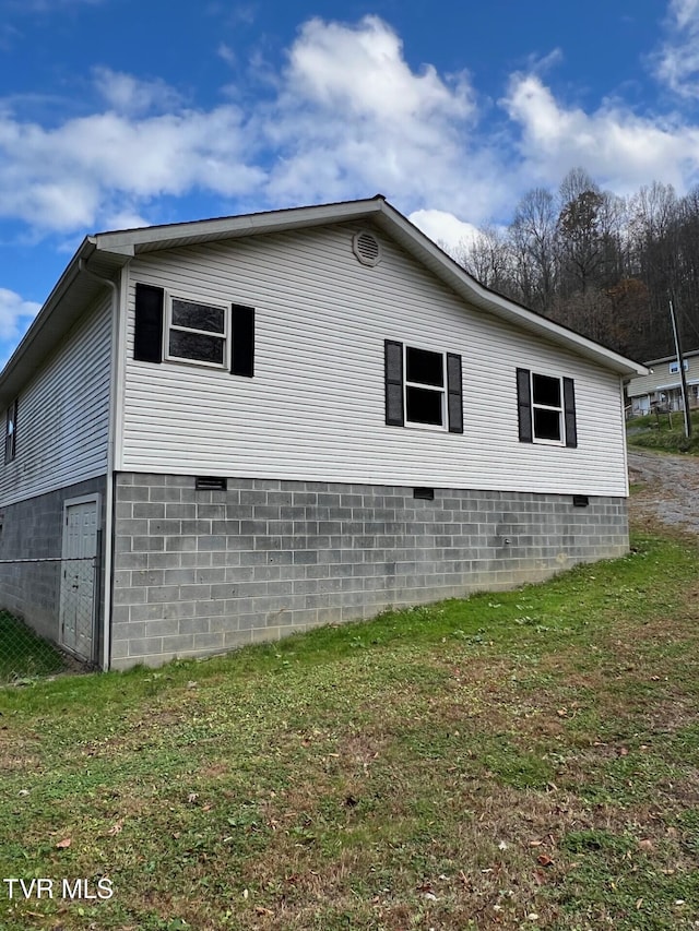 view of home's exterior featuring a yard