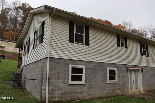 view of side of property with central AC unit