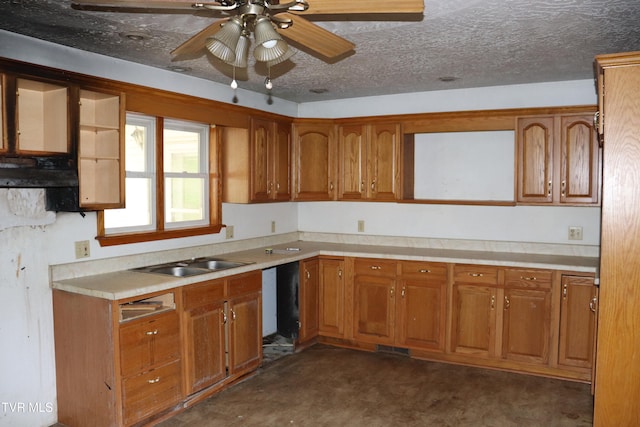 kitchen featuring sink, ceiling fan, and a textured ceiling