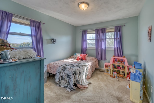 bedroom featuring baseboards and light colored carpet