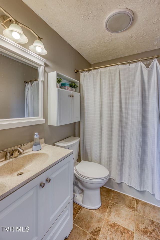 bathroom with a textured ceiling, toilet, vanity, and shower / tub combo