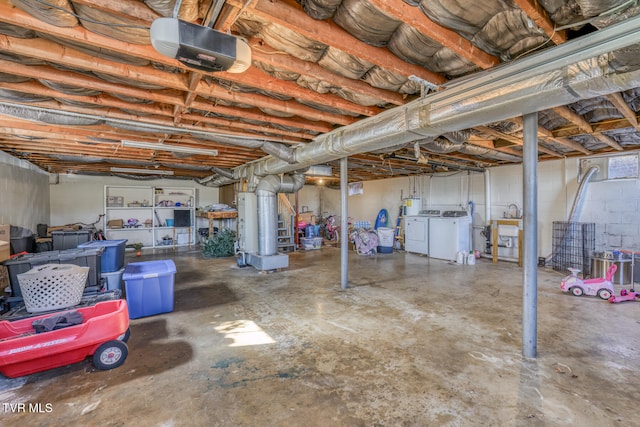 unfinished below grade area with washer and clothes dryer