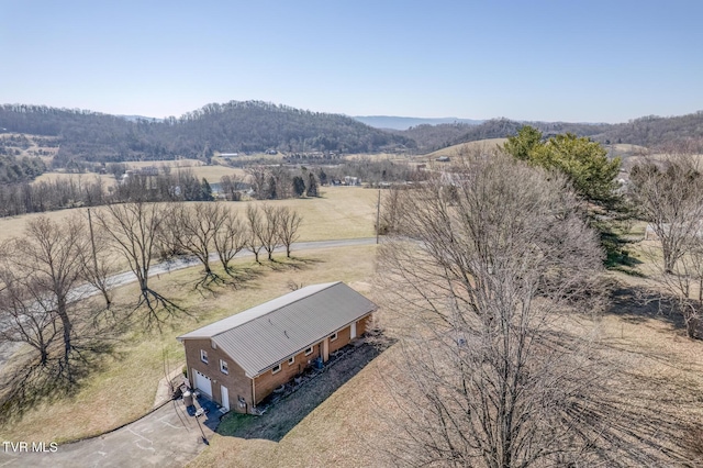 drone / aerial view featuring a mountain view and a rural view