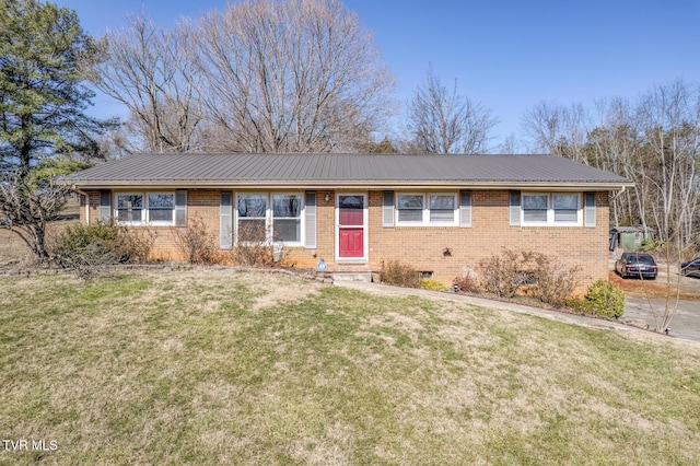 single story home featuring crawl space, a front lawn, metal roof, and brick siding