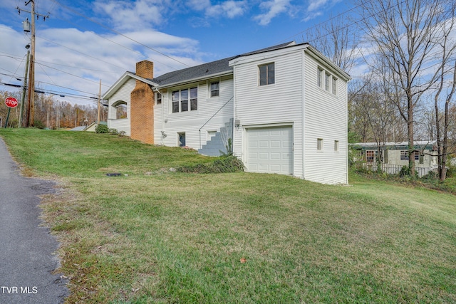 exterior space featuring a garage and a lawn