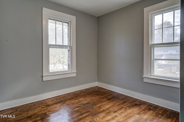 unfurnished room featuring dark wood-type flooring