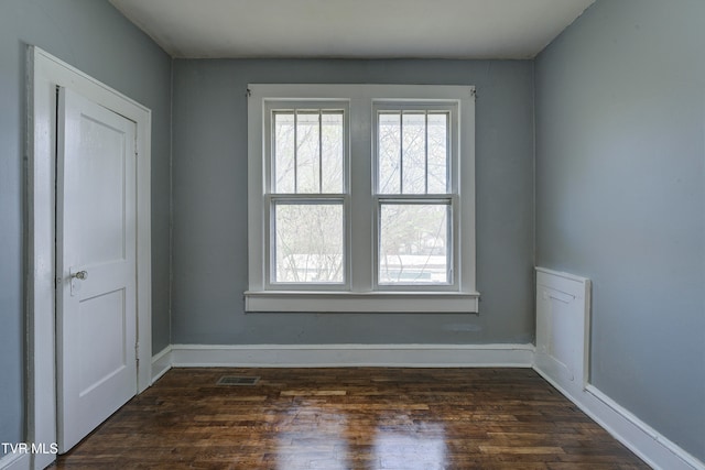 unfurnished room featuring dark hardwood / wood-style flooring