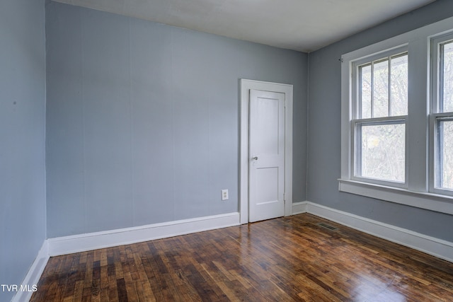 empty room featuring dark wood-type flooring