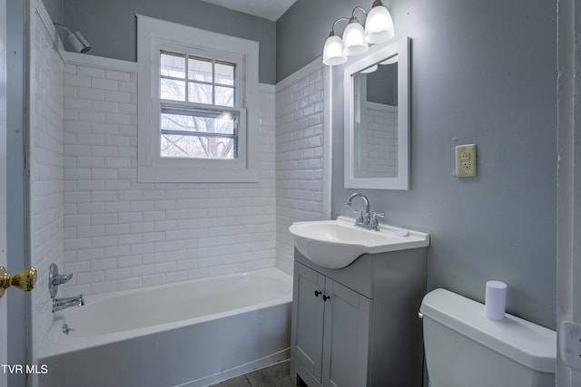 full bathroom with vanity, toilet, and tiled shower / bath