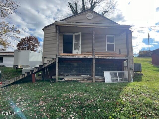 rear view of property featuring a yard