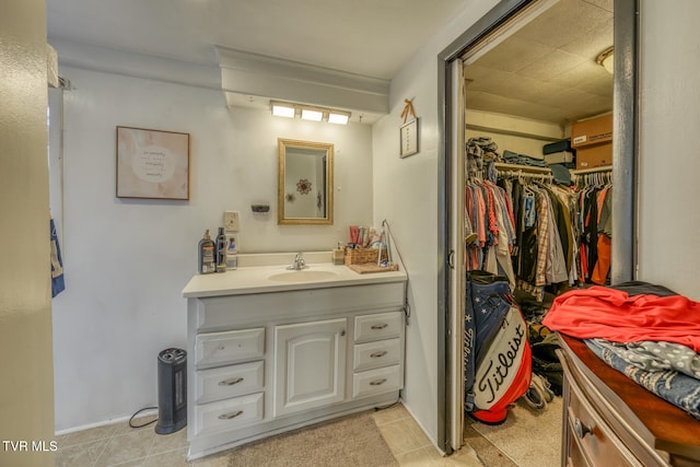 bathroom featuring tile patterned flooring and vanity