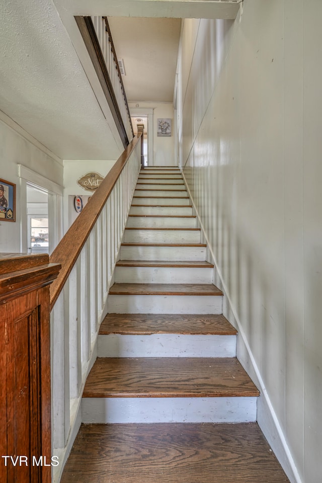 staircase with wood-type flooring