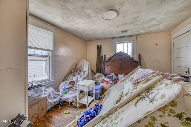 bedroom with hardwood / wood-style flooring